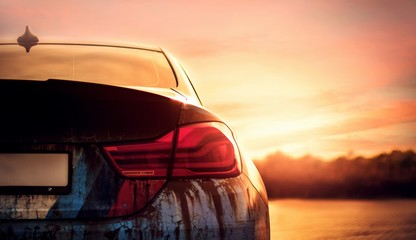 Poster - Closeup of a tail light of a modern car during the sunset in the evening