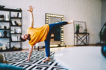 Fototapete - Sporty man doing yoga exercise in flat