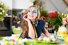 Pretty Young Women With Bunny Ears Parepaing Easter Decorations.  Easter Background. Bouquets Of Spring Flowers. Easter Eggs In Baskets.