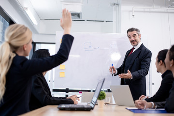 Caucasian business boss let his team mate staff asking about his report plan in meeting room. Co-working, teleworking, Online business conference concept.