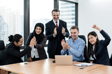 Wall Mural - Ethnic diversity business groups  are delighted with the results of their work on the laptop. Co-working, teleworking, Online business conference concept.