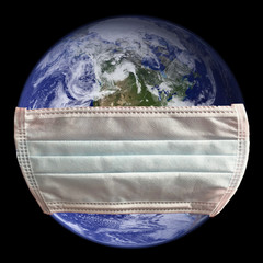 dirty used simple white face mask on planet earth, black background. concept of earth putting on a m
