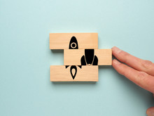 Start Up Concept With Wooden Blocks On A Blue Background, Hand Of A Businessman Pushes Wooden Blocks Together