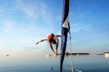 Man Diving From The Front Of A Sailboat