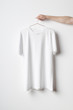 © Shablon - Men's Crew Neck T-Shirt Mock-Up - Man holding a white t-shirt on a copper wire clothes hanger
