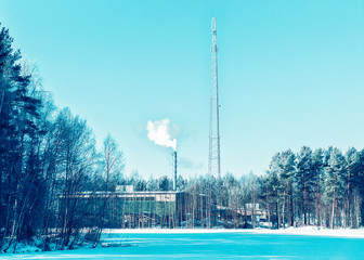 Wall Mural - Factory chimney and steam in winter countryside at Finland