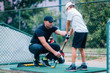 Golf Lessons. Golf instructor giving game lesson to a young boy.