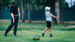 © Microgen - Golf – Personal Training. Golf Instructor Teaching Young Boy How to Play Golf.