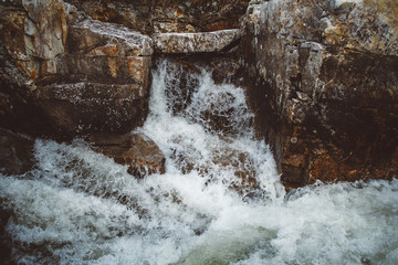 Wall Mural - stream of river among stones and rocks. stream in stone bed, fast mountain river among rocks, water 