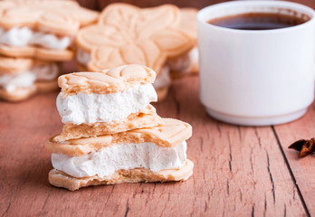 Wall Mural - Shortbread cookies with meringue in the form of a flower, on a light wood background.