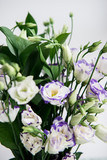 Beautiful bouquet of spring flowers in vase. Floral composition of fresh white violet eustoma flowers. Gift. Celebration concept. Blooming flowers.  