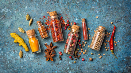 Wall Mural - Different spices in glass vials for tasty meals