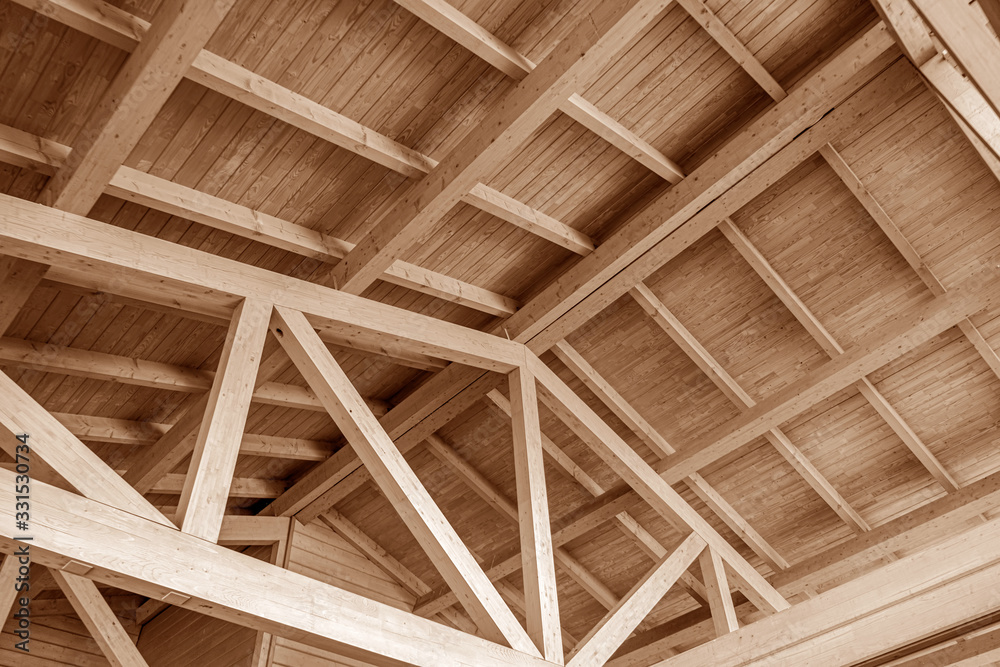 The construction of the wooden roof. Detailed photo of a wooden roof overlap construction.