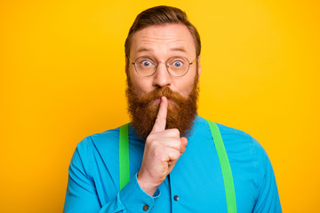closeup photo of funny red head guy tricky mood hold finger on lips asking not talk say speak tell w
