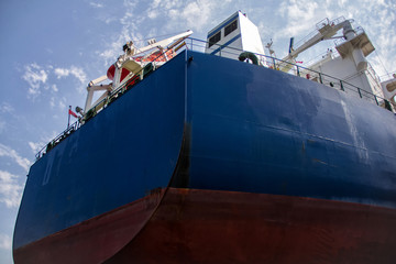 Poster - A large tanker cargo ship is being renovated and painted in shipyard dry dock.