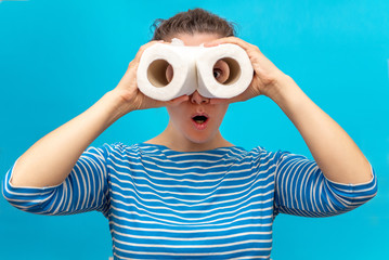 woman holds in her hands a pair of rolls of toilet paper. the hype around the demand for toilet paper during the global pandemic of the coronavirus. studio isolated.