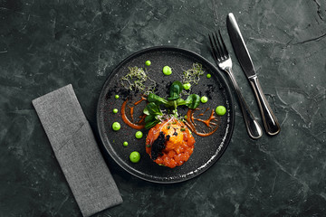 Wall Mural - Fresh tartare with salmon, avocado, red caviar on a plate, beautiful serving, Beautiful serving, traditional Italian cuisine, gray background, copy space. food concept