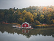 Lonely red cabin at a lake in Sweden during fall