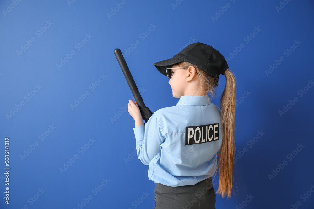 Cute little police officer on color background