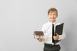 © Pixel-Shot - Portrait of little real estate agent with model of house on light background