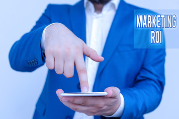 Poster - Handwriting text Marketing Roi. Conceptual photo the contribution to profit attributable to marketing Businessman in the blue suite with lap top pointing with finger