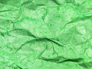 Pattern of green crumpled paper texture background.