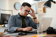 © JustLife - Designer in office. Businessman working on new architect project.