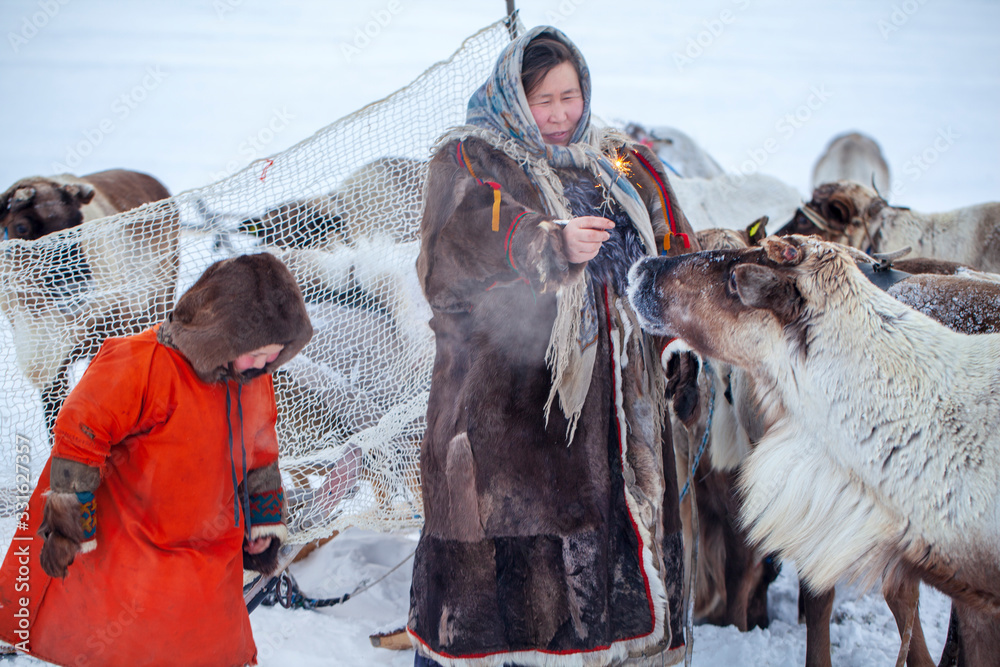 The extreme north, Yamal, the past of Nenets people, the dwelling of the peoples of the north, a family photo near the yurt in the tundra - obrazy, fototapety, plakaty 