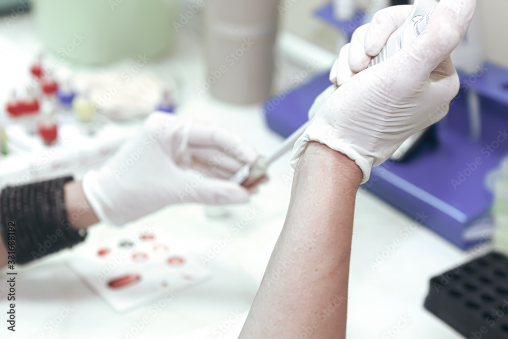 Scientist working in his laboratory. A blood test is a laboratory ...