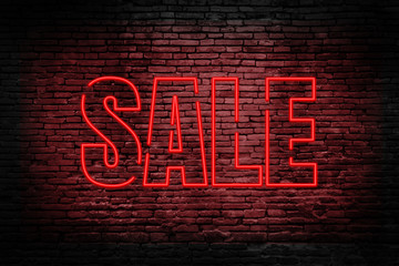 Sale advertisement, realistic red neon sale text banner on black brick walls.