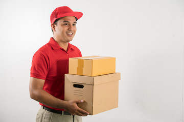 Wall Mural - Red Delivery handsome asian man holding parcel cardboard box on isolated white background.