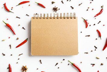Wall Mural - Recipe book and red chili pepper isolated on white background