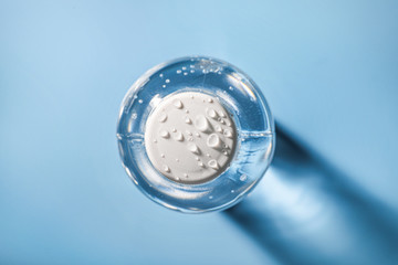 Wall Mural - Top view of plastic water bottle on blue background