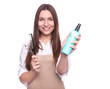 © LumenSt - Young woman in apron isolated on white background. Hairdresser concept