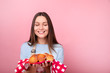 © LumenSt - Young woman in apron is standing by yellow background