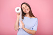 © LumenSt - Young woman holds toilet paper on  pink background.