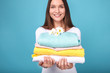 © LumenSt - Young woman in apron  on  blue background. Cleaning concept