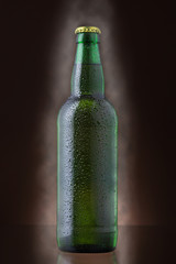 Wall Mural - Bottle of beer covered by water drops on brown background