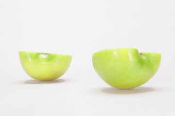 Closeup macro of two halves of a apple on the white