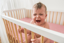 The Baby Cries And Calls Mum From A Bed