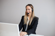 Young Woman Working In Call Center. Customer Support Woman In Office
