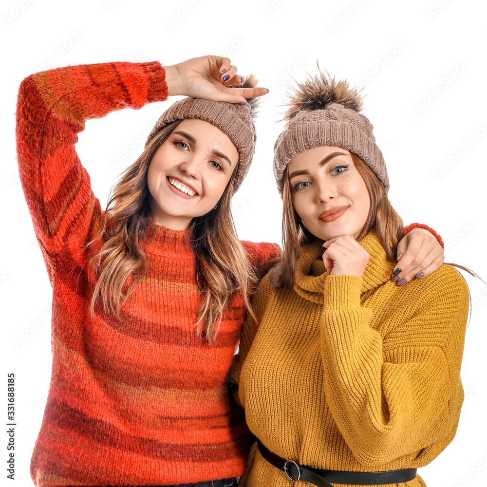 Young women in warm sweaters on white background