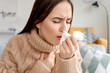 © Pixel-Shot - Coughing young woman at home