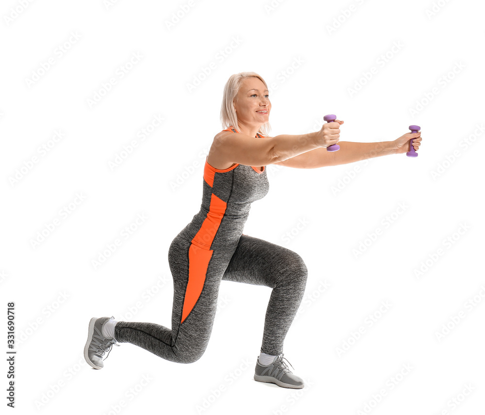 Sporty mature woman doing exercise with dumbbells on white background