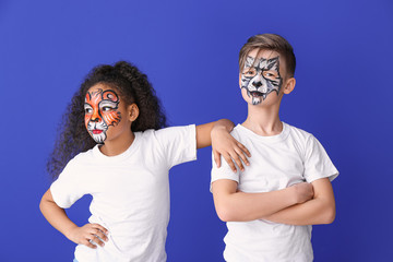 Canvas Print - Funny little children with face painting on color background