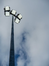Powerful LED Light On A Metal Pole Turned On, Cloudy Sky Background. Concept Sport Event, Game.