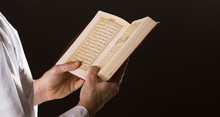 Man With Open Quran In Hands