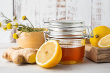 Alternative Medicine, Natural Home Remedy For Cold And Flu. Glass Jar With Honey, Ginger, Lemon And Camomile