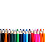 Fototapeta Tęcza - A set of colored pencils on a white background. School supplies.
