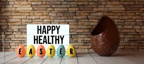 Cuadros en Lienzo easter eggs with message HAPPY HEALTHY EASTER with big chocolate egg in front of